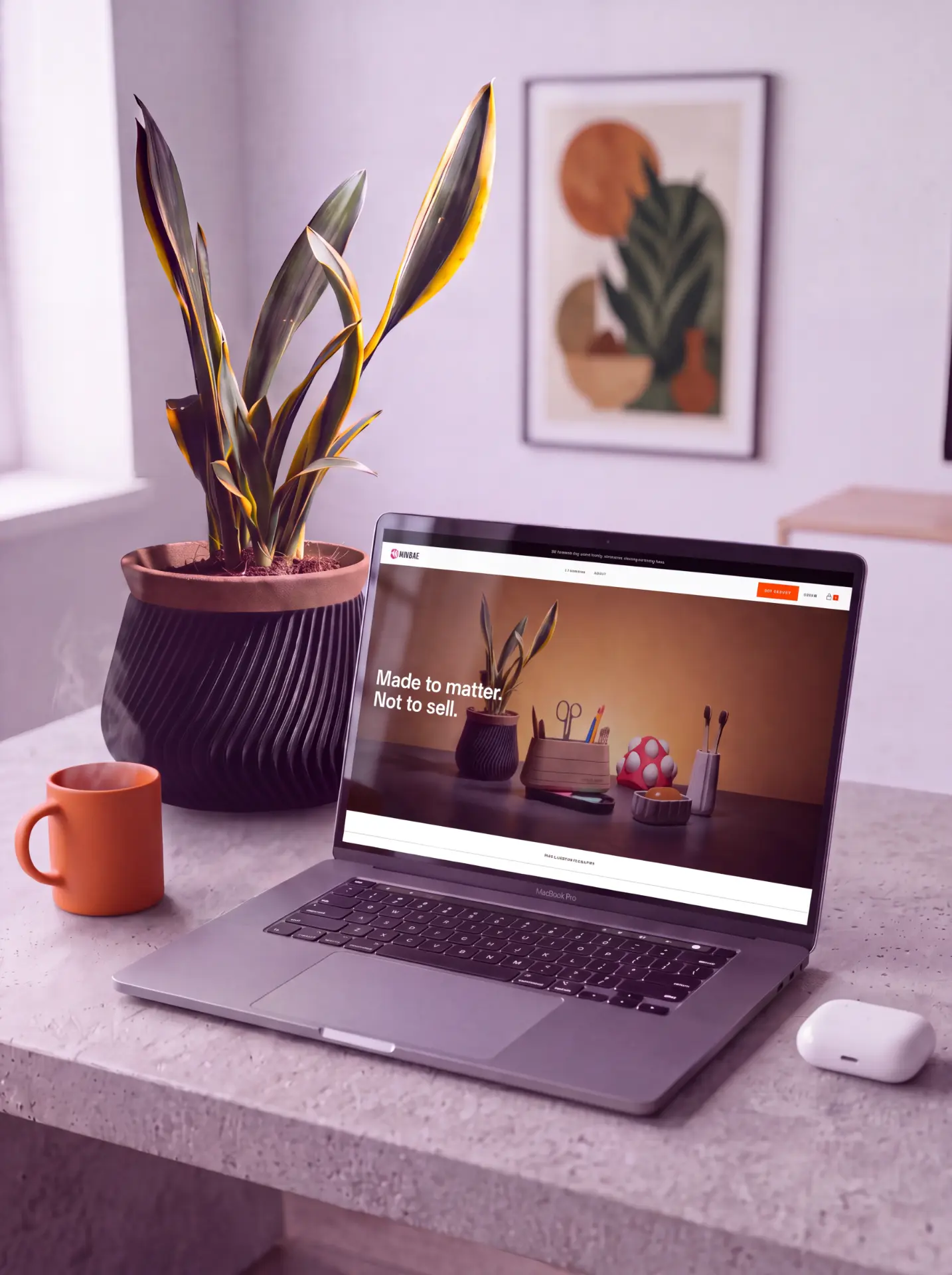 Dindie storefront on a laptop beside a 3D-printed planter on a desk